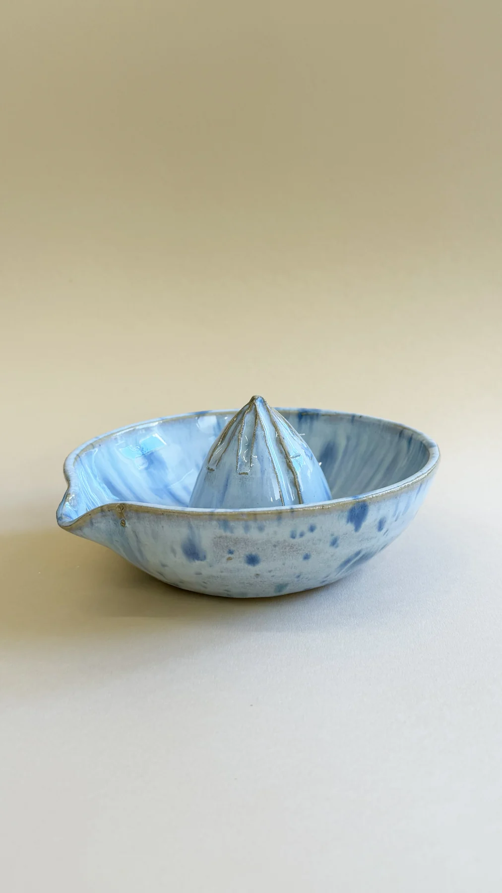 Blue ceramic citrus juicer made by Emily
